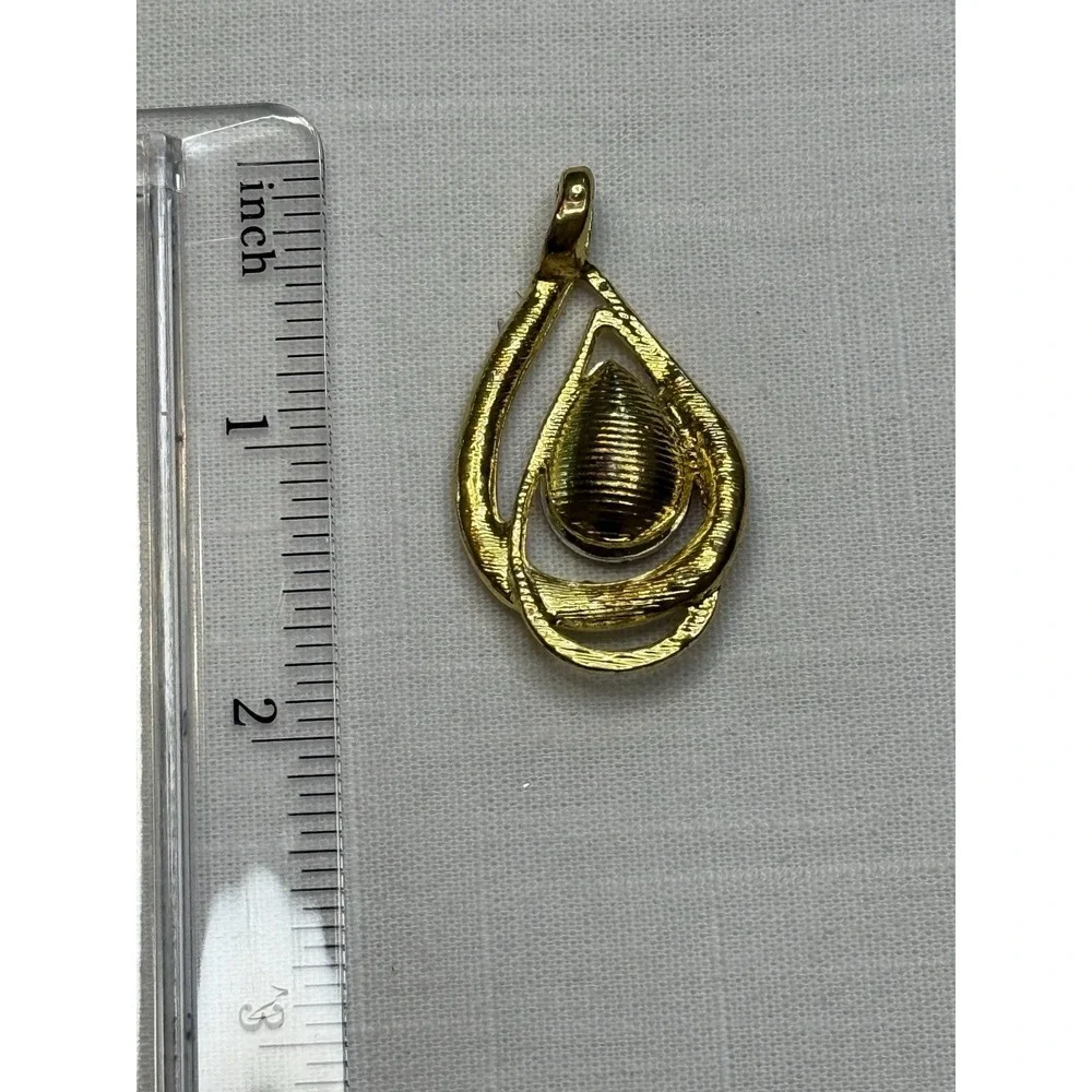 Gold tone red gem & rhinestone pendant